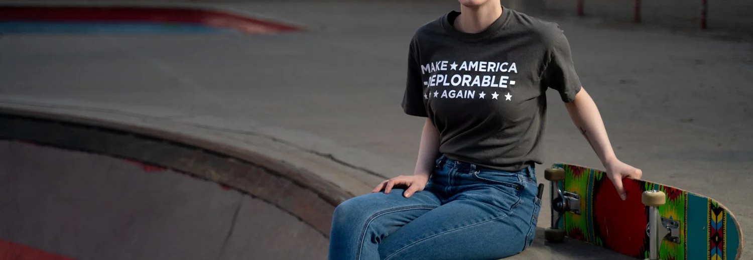 A skater sitting on a ramp in a Make America Deplorable Again tee